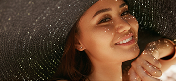 Young woman smiling in a sunhat