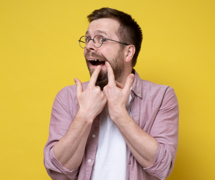 Man pointing at missing tooth